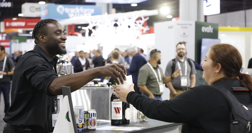 Bartender giving woman a drink at convention.