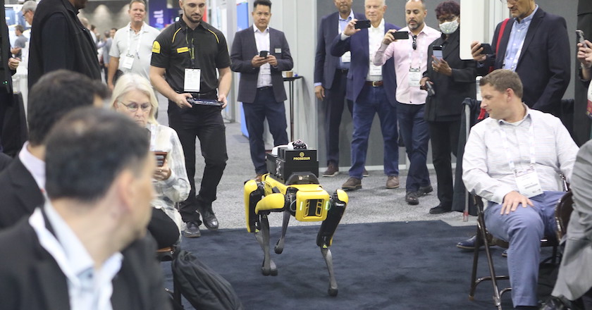 Robotic dog walking down the stage with an audience.